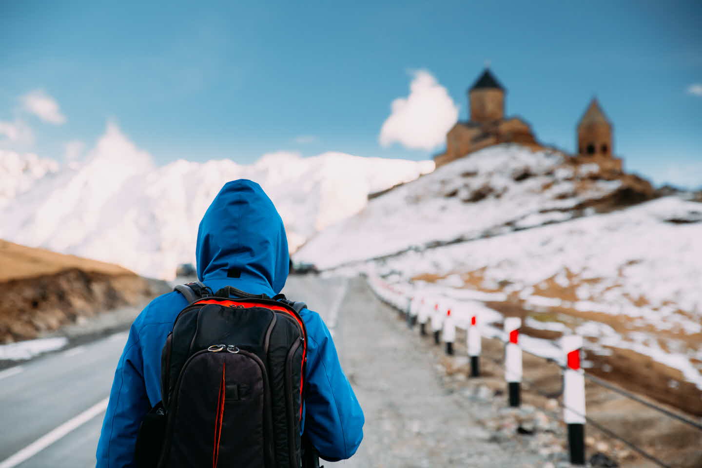 stepantsminda-gergeti-georgia-man-tourist-backpack-9CYMBR3